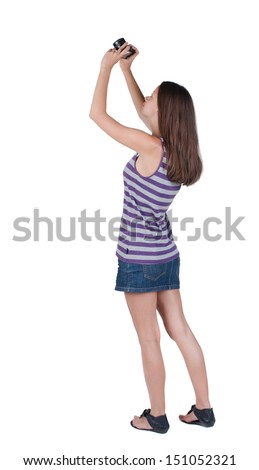 Back view of woman photographing. girl photographer in dress. Rear view people collection.  backside view of person.  Isolated over white background.