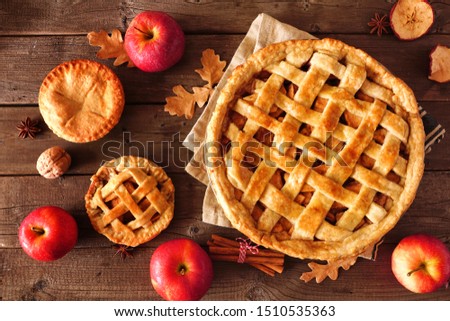 Homemade autumn apple pies, top view table scene with a rustic wood background Royalty-Free Stock Photo #1510535363