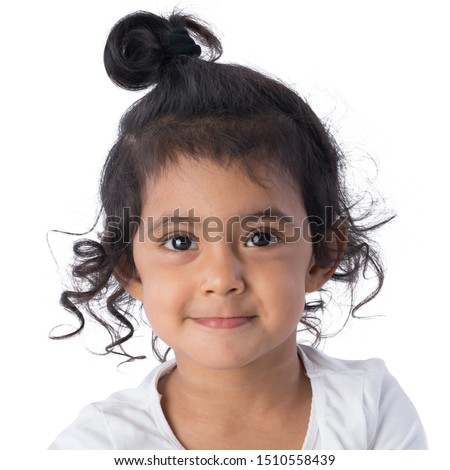 Adorable little gir with curly hairl being happy, smiling contently. A portrait of an Indian Thai beautiful girl.
