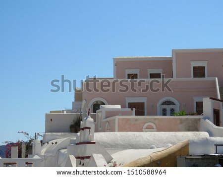 Whitewashed cubiform buildings in the Greek Village of Oia, on the Island of Santorini, provide a picturesque and very unique landscape. Royalty-Free Stock Photo #1510588964