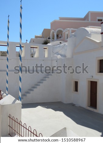 Whitewashed cubiform buildings in the Greek Village of Oia, on the Island of Santorini, provide a picturesque and very unique landscape. Royalty-Free Stock Photo #1510588967