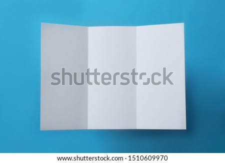 Empty flyer on blue background, top view. Mockup for design