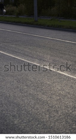 black asphalt road glistens in the sun