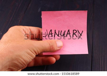 January Word on paper in hand