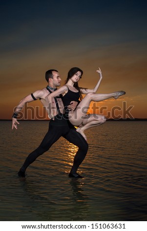Two young men dancing on the surface of the water