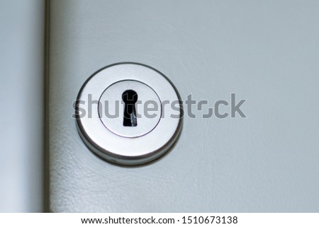 Keyhole of the modern white door. Concept of security, access, safety.