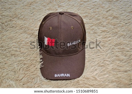 brown cap with the flag of Bahrain on the fleecy coating