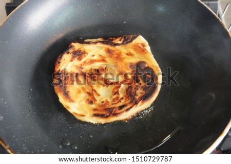 A picture of instant "roti canai" or pratha overcooked and burnt.
