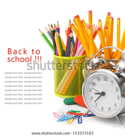 Alarm clock and school accessories on a white background.
