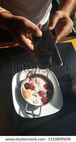 photo of fried sausage eggs with mobile phone