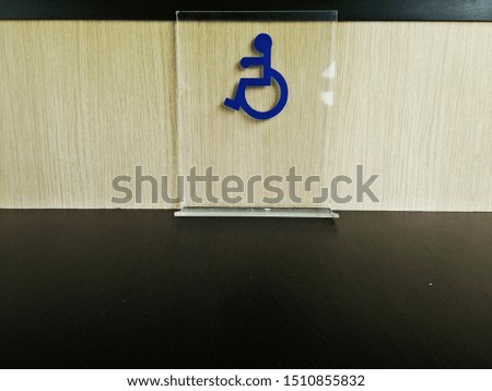 Sign indication the area for the disabled on the table .