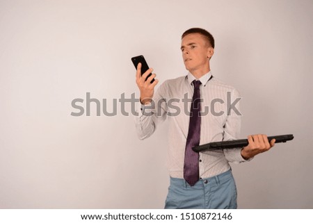 business man with laptop looks at the phone on an isolated background technology internet boss