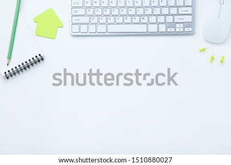 Computer keyboard with mouse and notepad on white background