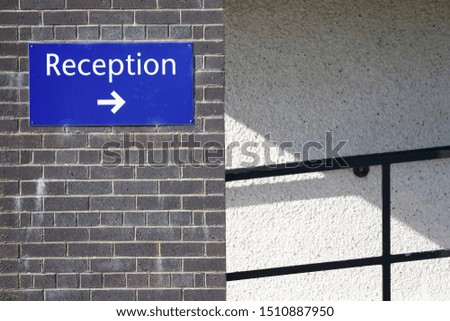 Reception direction arrow sign at office building entrance