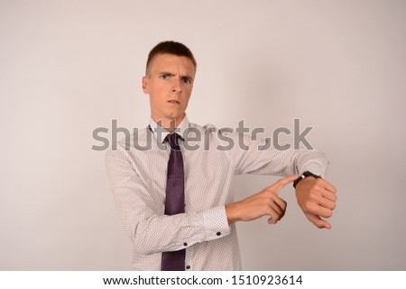 emotions surprised business man with a clock on a gray background career
