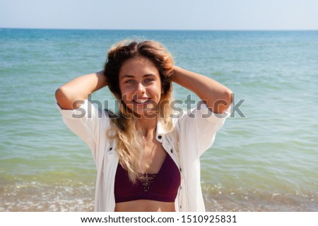 girl stands against the sea