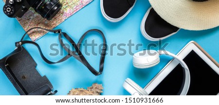 Flat lay traveler accessories on  blue background with blank space for text. Top view travel or vacation concept. Summer background.Banner