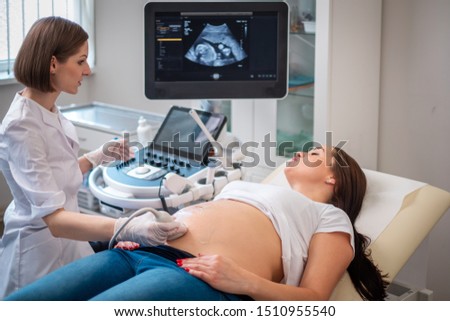 Pregnant woman on utltrasonographic examination at hospital Royalty-Free Stock Photo #1510955540