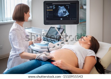 Pregnant woman on utltrasonographic examination at hospital Royalty-Free Stock Photo #1510955543