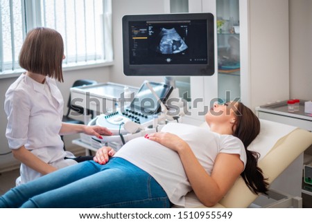 Pregnant woman on utltrasonographic examination at hospital Royalty-Free Stock Photo #1510955549
