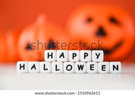 Halloween background orange with word blocks happy halloween decorations and pumpkin jack o lantern funny spooky on white wooden table happy holiday concept 