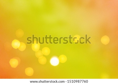 Abstract blurred background of yellow & golden bokeh light on gradient seamless pattern, copy space. Colorful texture of Christmas or new years event light in circle shape, festive holiday concept