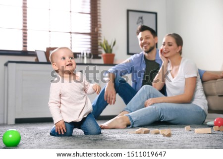 Parents spending time with their baby at home