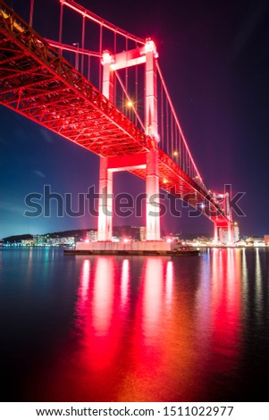 Wakato bridge in Kitakyushu, Fukuoka, Japan at night color red landscape long exposure photo. 