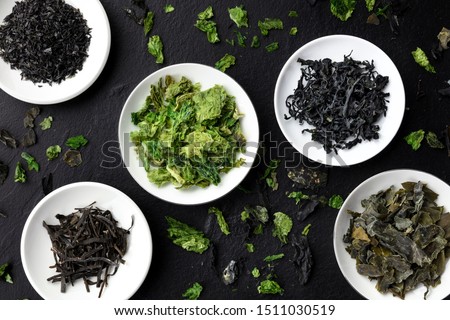 Various dry seaweed, sea vegetables, shot from above on a black background