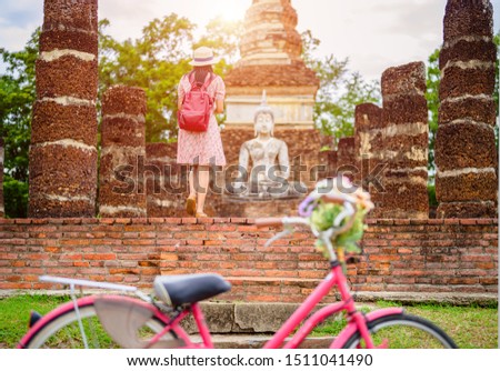 woman tourist enjoy walking to see the historic park of Thailand, exciting to explore the wonderful place of sightseeing