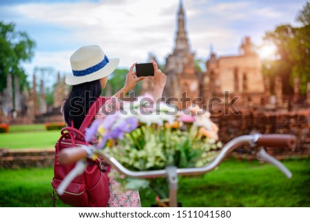 woman tourist enjoy walking to see the historic park of Thailand, exciting taking photo to the wonderful place of sightseeing
