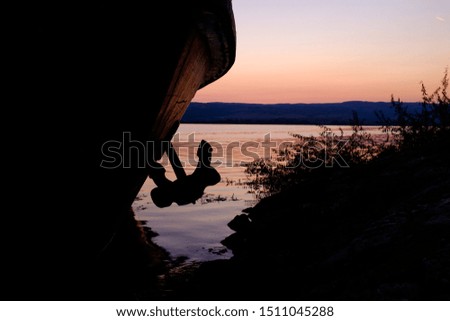 Anchor on a boat in the harbor, early morning, dawn time, silhouette 