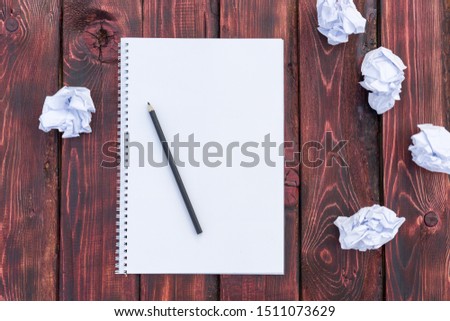 Crumpled paper is scattered on a wooden table. Concept of creative crisis, brainstorming, lack or search for ideas, thoughts, mistakes. Paper in the form of balls. You can place text on paper. Image. Royalty-Free Stock Photo #1511073629