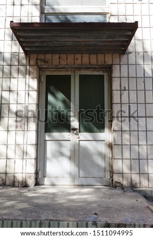 
Old vintage wall with worn metal door