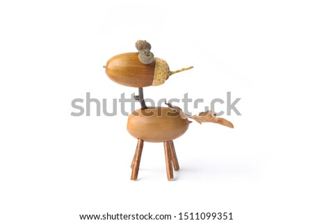 Cute small horse made from acorns isolated on white background. Creative funny animal figure made from acorn in autumn time. 
