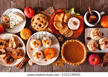 Autumn food concept. Selection of pies, appetizers and desserts. Above view table scene over a rustic wood background. Royalty-Free Stock Photo #1511138405