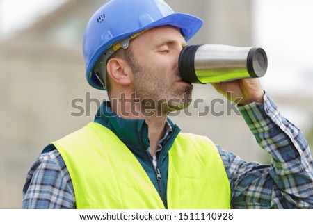 builder foreman or repairman drinking coffee