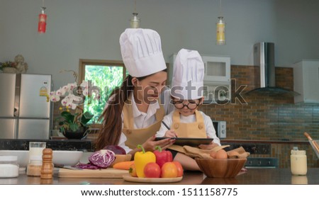 Family mom teaching the cute boy and cooking Make bread. Healthy lifestyle concept