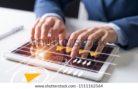 Businessman analyzing financial data. Virtual 3d interface above tablet computer screen. Interactive financial diagrams and digital data visualization. Modern smart technology in business process