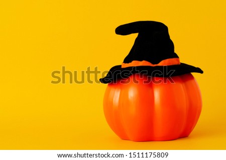 Orange pumpkin  with hat black for Halloween concept backgrounds with space for text