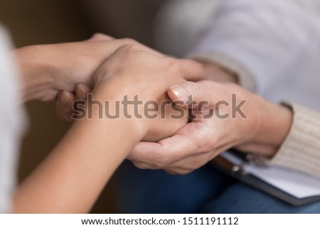 Close up of attentive female doctor hold patient hands show empathy and love, woman nurse or gp talk with girl client comfort caress support hearing bad results or news, medicine care concept Royalty-Free Stock Photo #1511191112