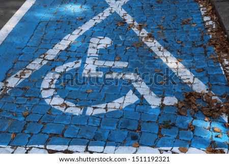 White disabled parking sign painted on blue background stock photo.Empty parking space.