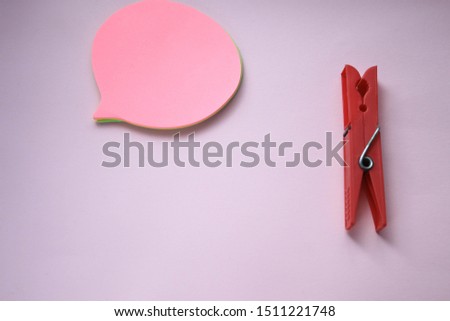 Clothespin and sticker on pink background