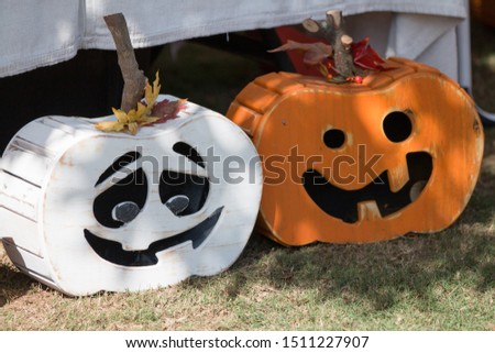 Pictures of various pumpkin carved faces on wood themed pumpkin.