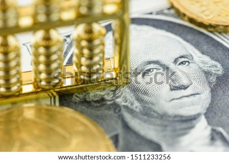 Money supply, economic concept : Chinese abacus on one US dollar paper currency with image of George Washington, depicts global infleunce and major impact of the USD, FED central bank around the world Royalty-Free Stock Photo #1511233256