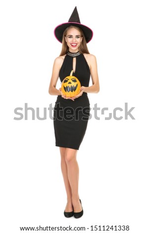 Beautiful woman in black costume holding halloween pumpkin on white background