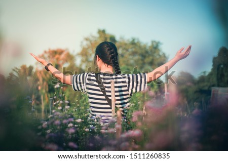 women raise their arms thank God along with praising God