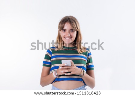 Happy young woman using smartphone over white background