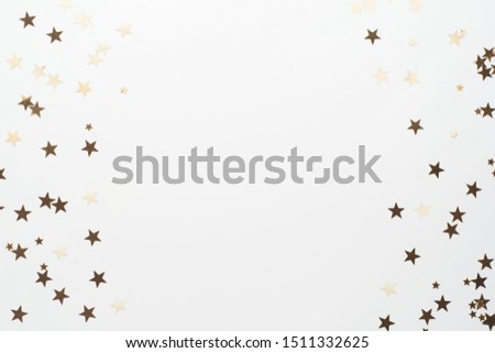 Golden glitter, confetti stars isolated on white background. Christmas, party or birthdau background. Flat lay.
