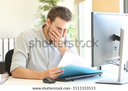 Worried businessman complaining discovering mistake on document at office Royalty-Free Stock Photo #1511333513